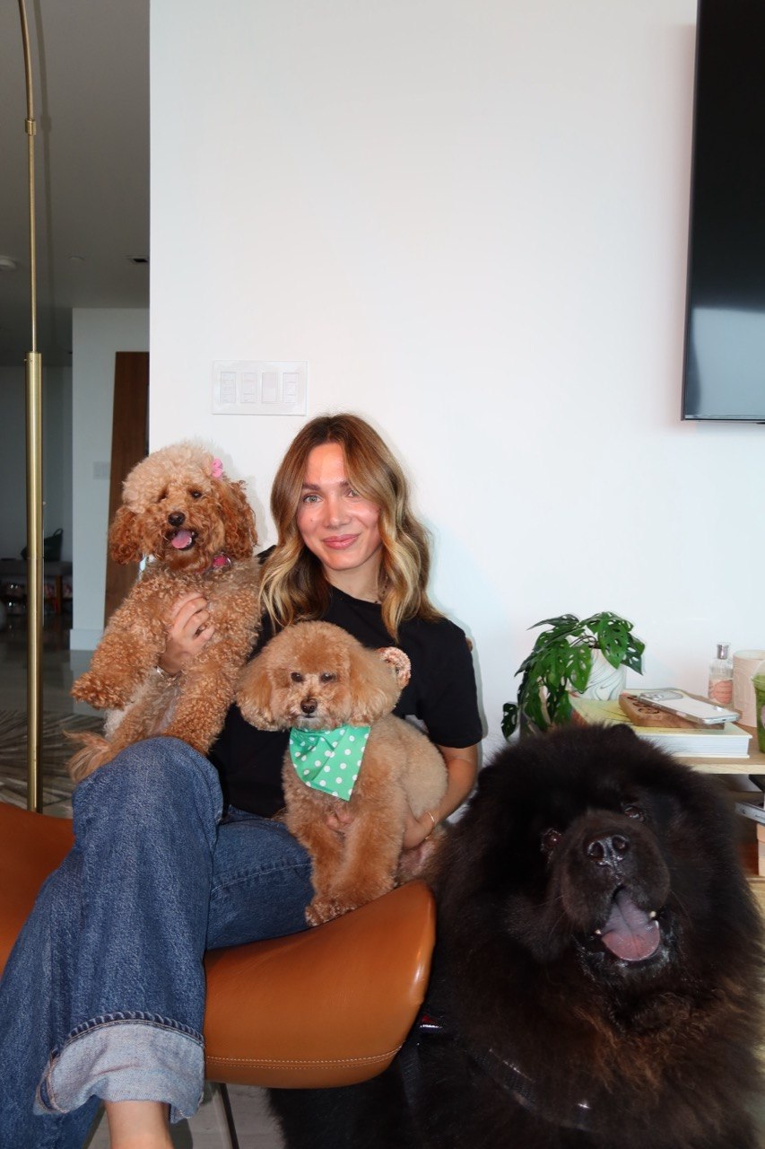 Pawsport Concierge founder with her Maltipoo Nounours and two other dogs at home in Miami